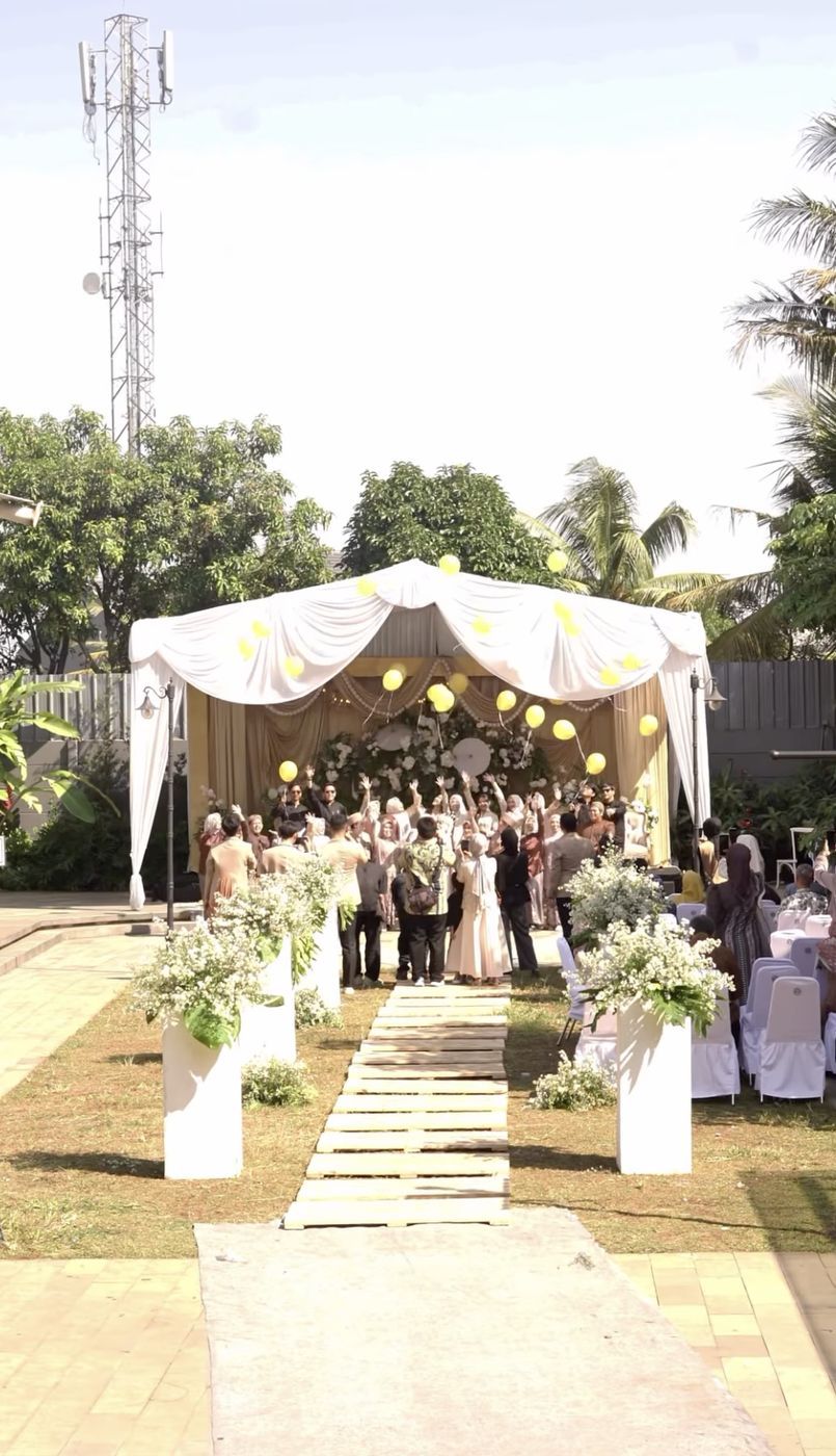 Akad di taman dengan tenda putih dan lorong bunga